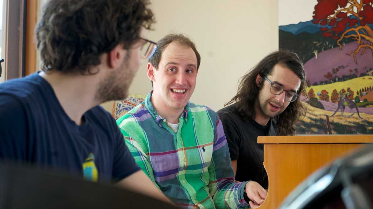 Three men playing music together.''