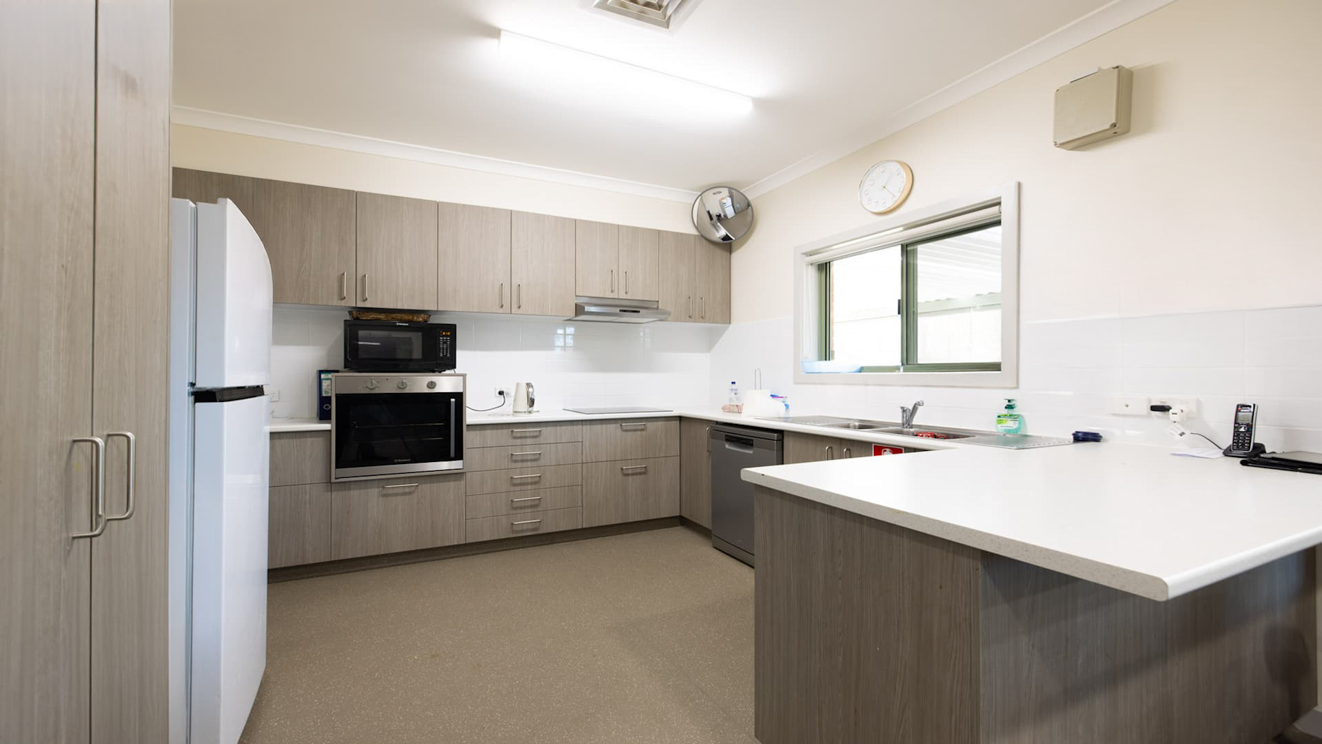 Kitchen space with accessible oven and bench tops.