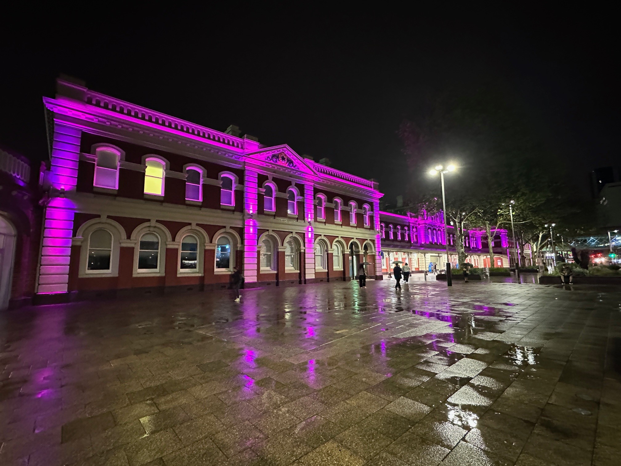 Perth station lit up in pink.