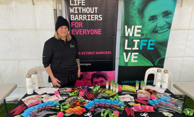 A staff member at a Life Without Barriers stall.