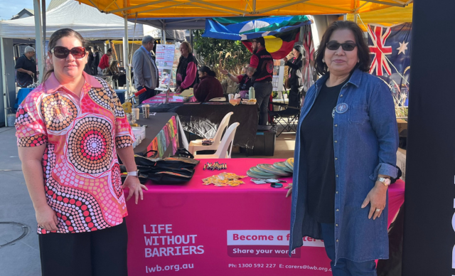 Two staff members at a Life Without Barriers stall.