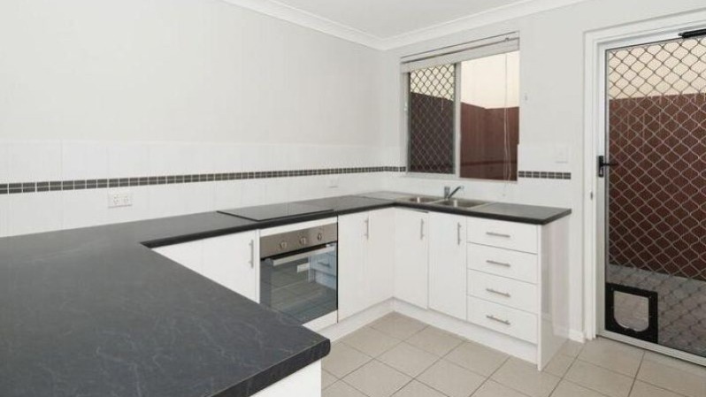 White kitchen cabinets, dark marble counter tops, tiled floor kitchen