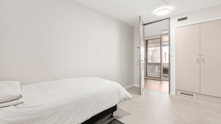 --Bedroom with a single bed and wardrobe.--