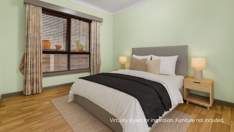 Modern bedroom with a queen-sized bed, grey upholstered headboard, white bedding, black throw blanket, beige accent pillows, bedside tables with lamps, wooden flooring, and large window with curtains and blinds.
