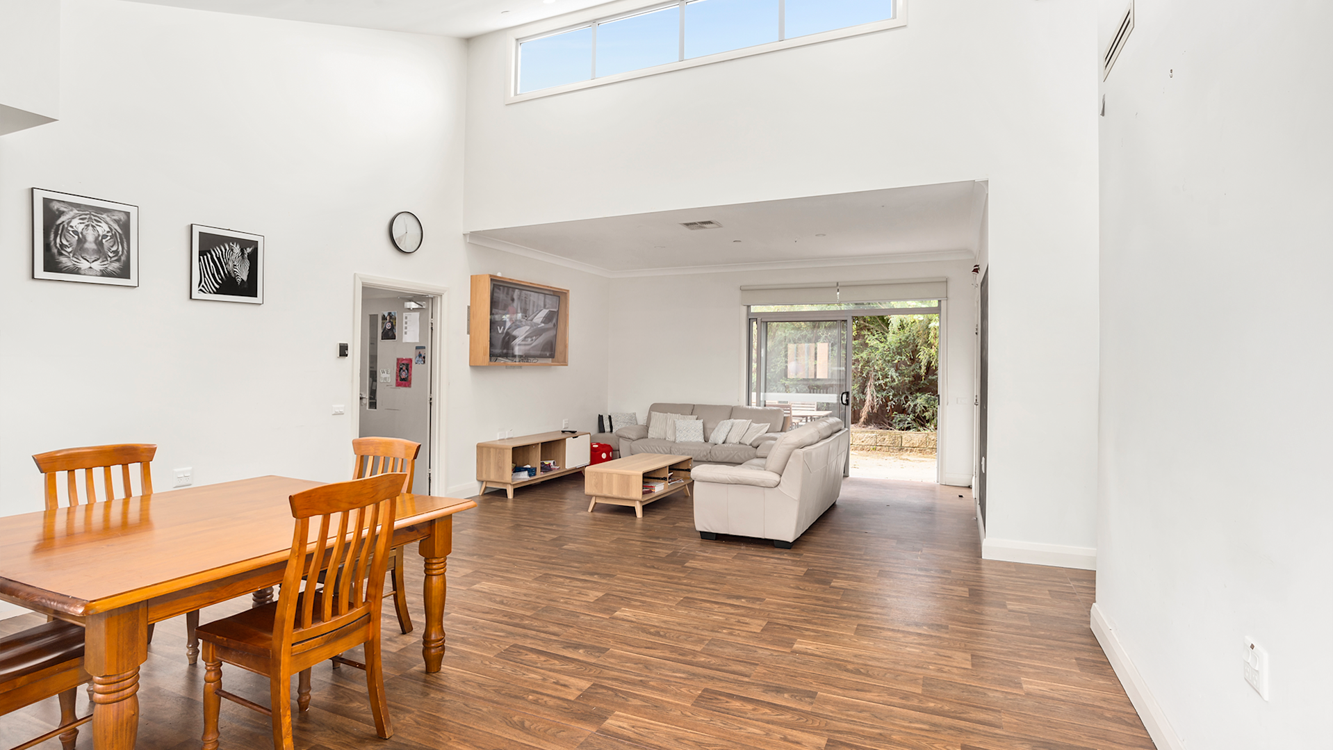 --Dining area with a wooden table and four chairs. The Dining area is adjacent to the loungeroom.--