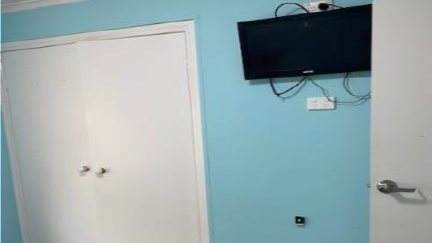 Bedroom built in robe and TV on wall