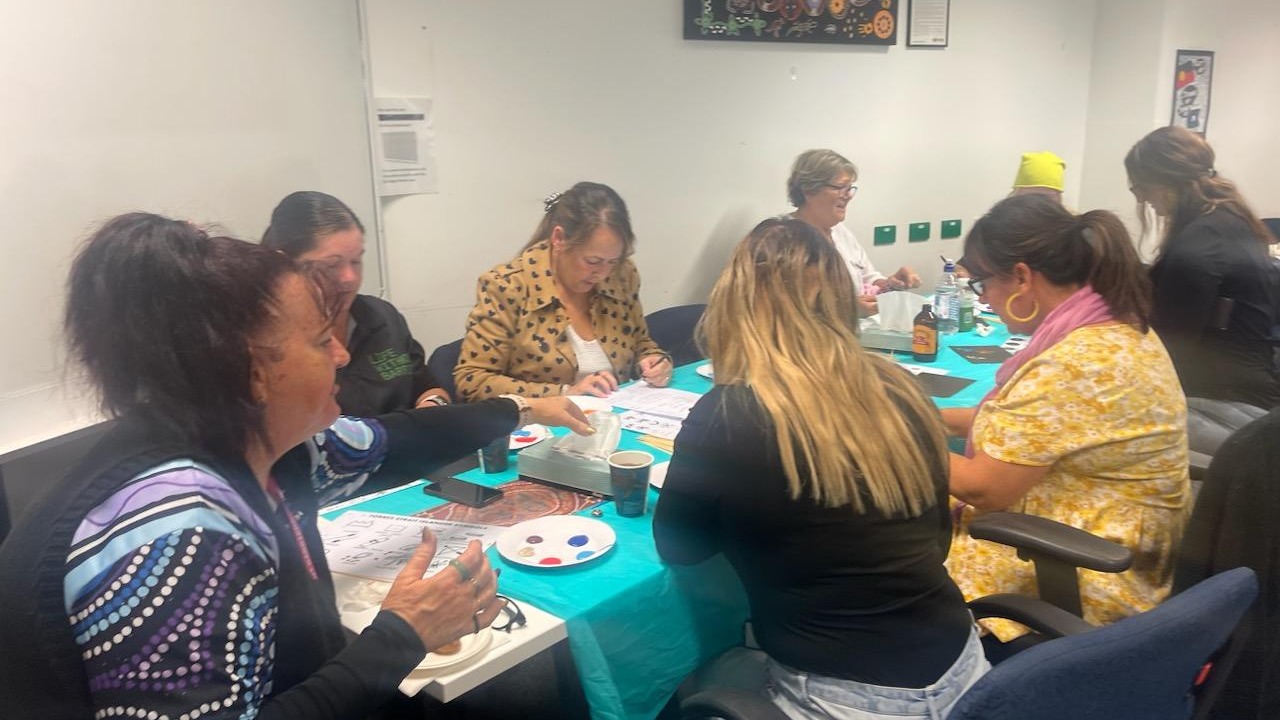 Ipswich staff engaging in a weaving activity.