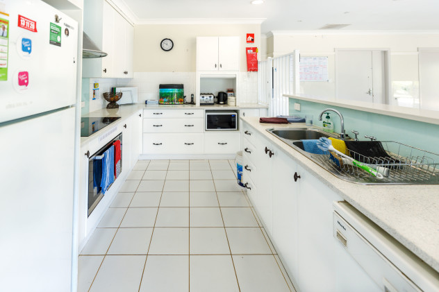 Large bright tiled kitchen. 