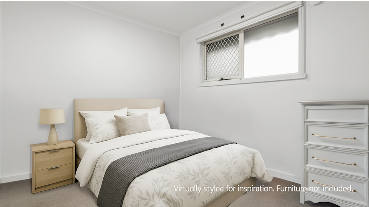 Compact bedroom with white walls, a large window with a security screen, and elegant cream and grey bedding beside a white dresser.