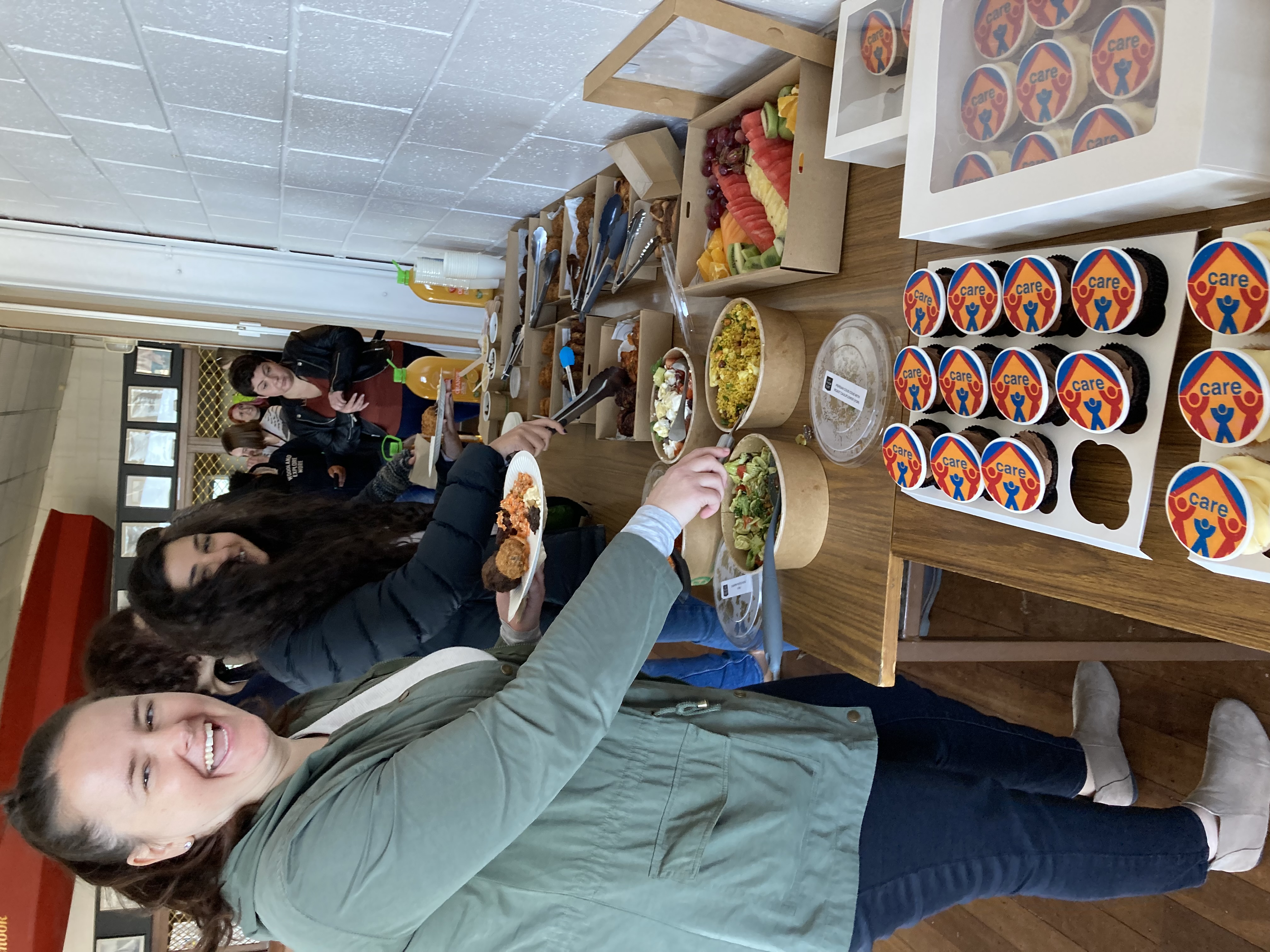 Staff members celebrate CARE certification with CARE cupcakes.