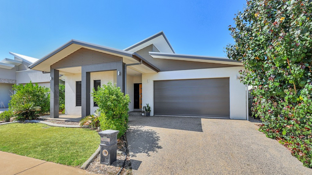 --Front of home with driveway and lawn.--