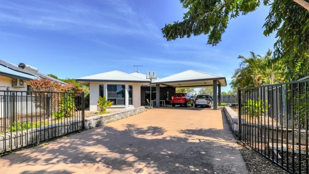 --Front of the house with a concrete driveway leading to a carport--