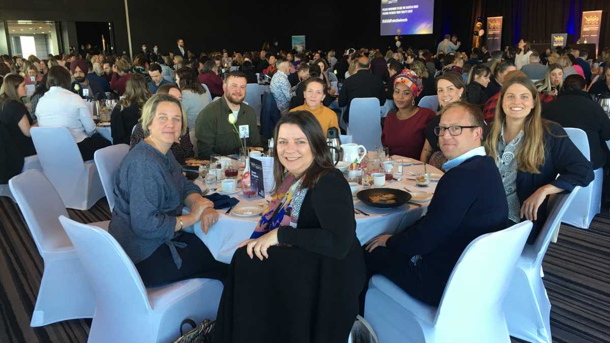 South Australia CYF Director, Life Without Barriers staff and a foster carers sitting at a table in a conference room.