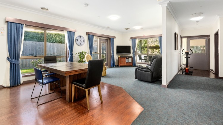 Mount Waverly open living room/kitchen. Big windows, carpet floor, lounges facing TV. 