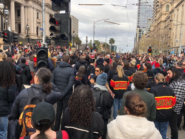A large crowd gathered in front of Parliament House as part of the NAIDOC March. 