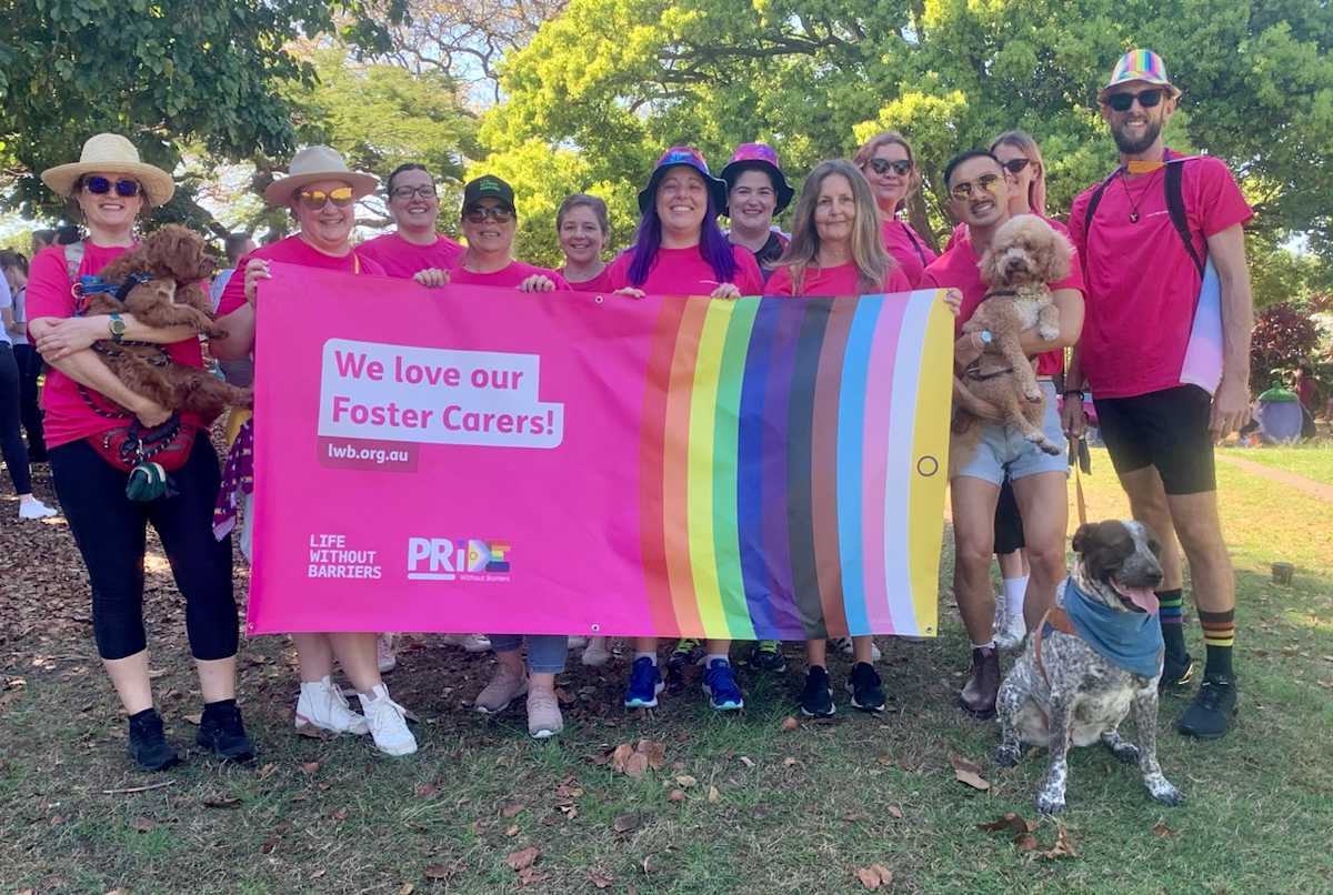 Brisbane Pride 2022 2 Staff and carers holding a 'we love our foster carers' rainbow sign.