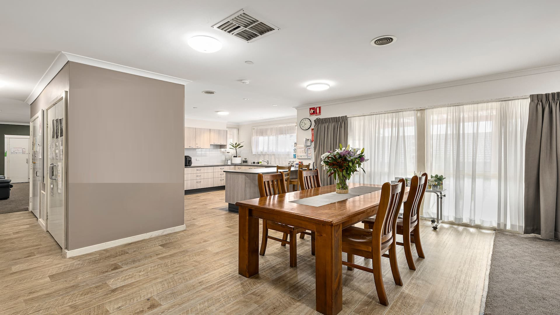--Kitchen, two windows and a dining table.--