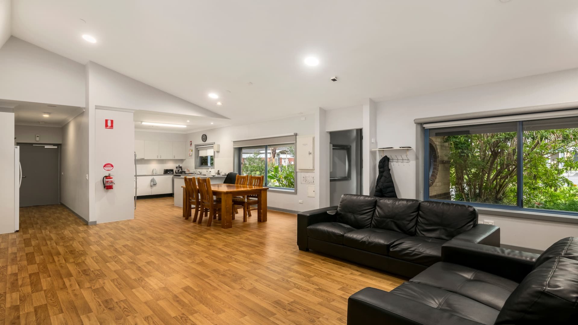 open plan loungeroom, dining room with large, windows overlooking the garden