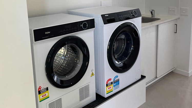 Bright white laundry with a washer and dryer.
