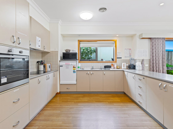 Large, U shaped kitchen with plenty of storeage and modern appliances.  Large window above the sink and hard wood flooring.  Kitchen overlooks dining and lounge space.