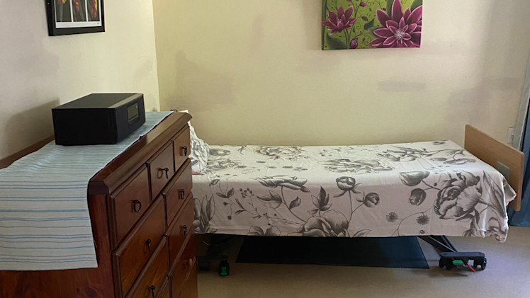 --Bedroom with a bed and dresser. --