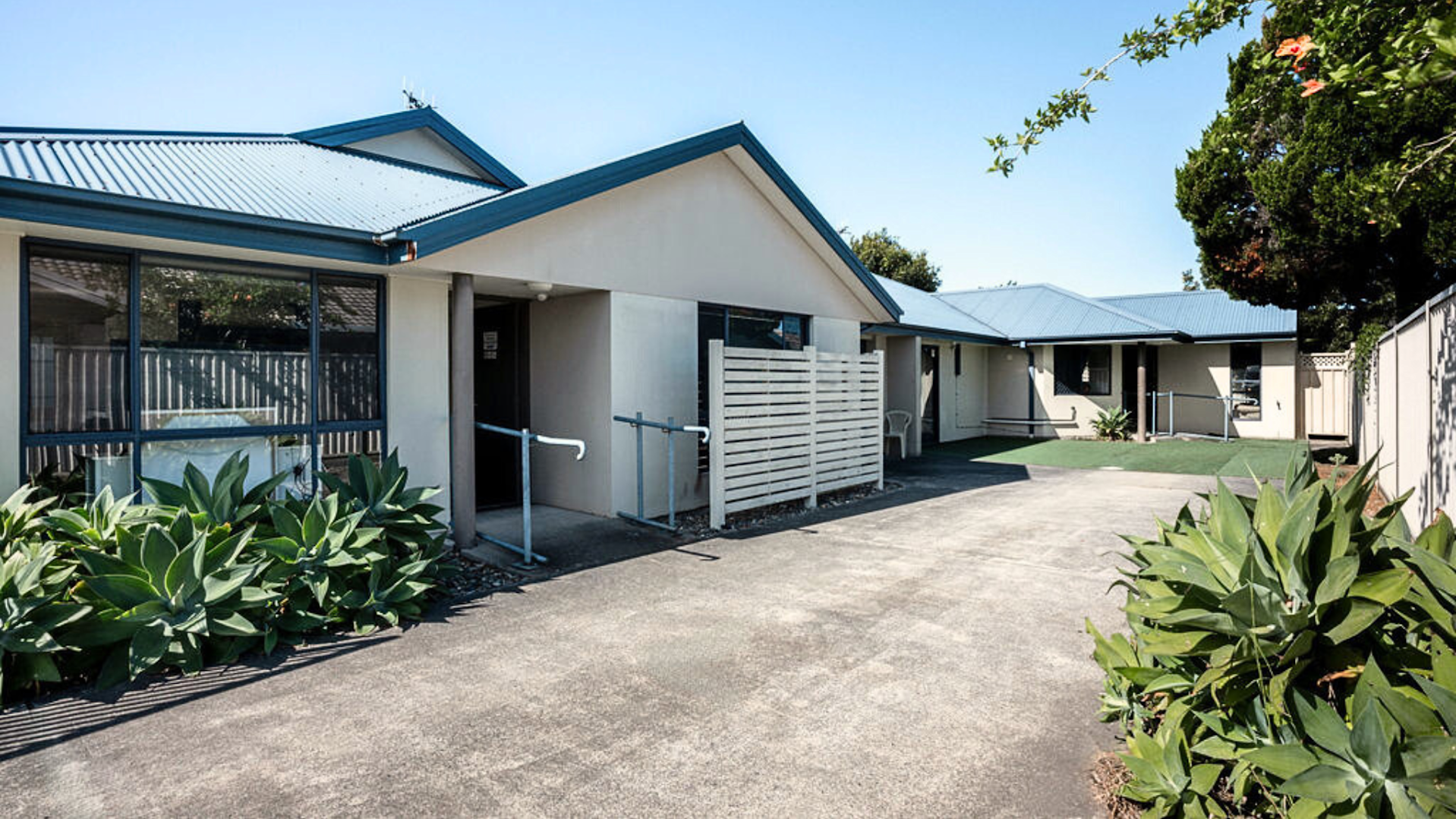 Port Macquarie house with a concrete driveway and a ramp at the front door.
