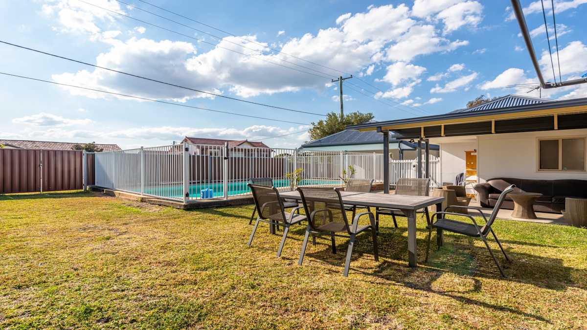 Backyard with an outdoor dining set, and patio and an outdoor fenced pool.