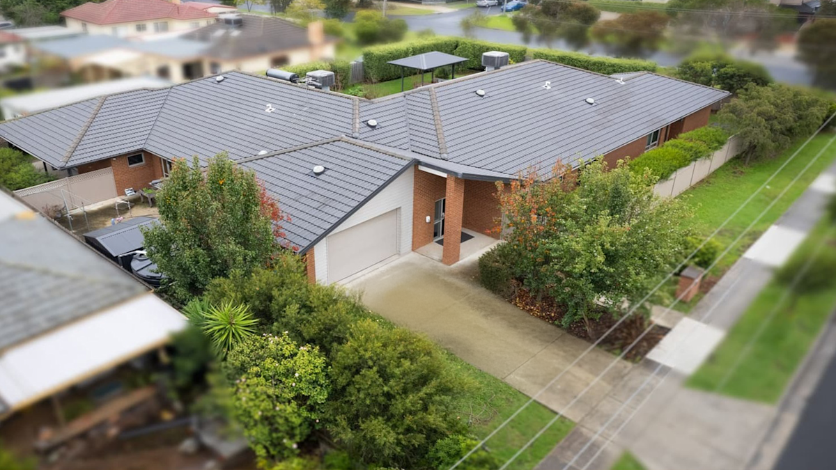 Aerial view of the front driveway and front door entrance to the house.