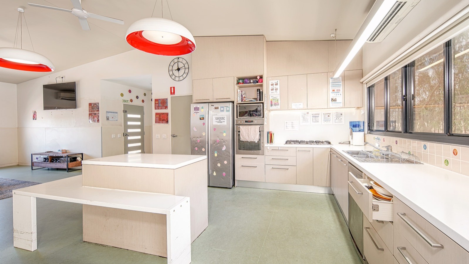 --Large bright kitchen with wrap around kitchen, island bench, double fridge.--