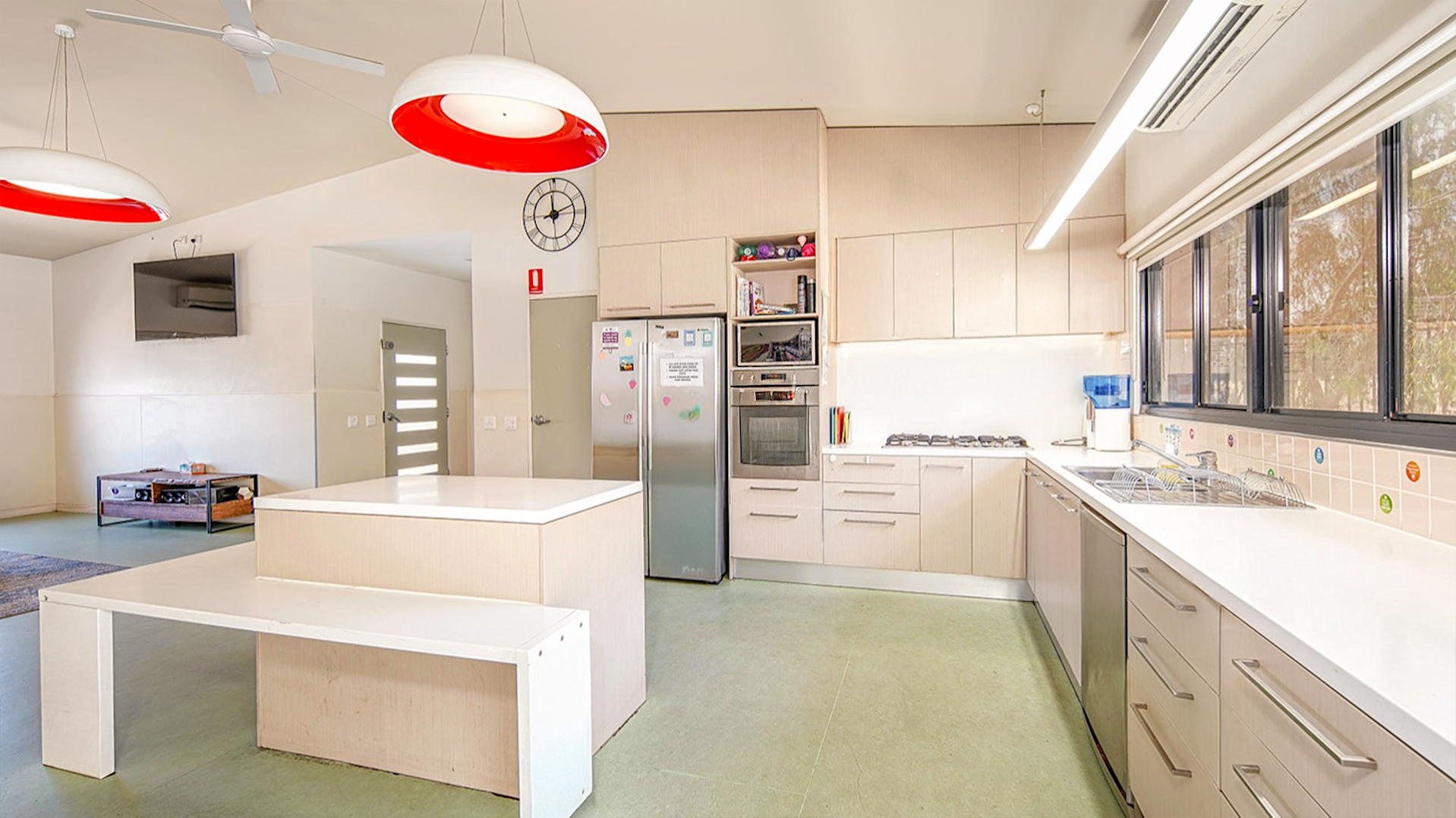 --Large bright kitchen with wrap around kitchen, island bench, double fridge.--