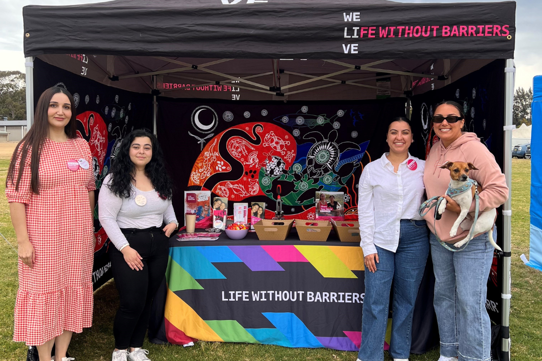 Staff stand in front of the Life Without Barriers booth at the My Forever Family Foster and Kinship Care Picnic.