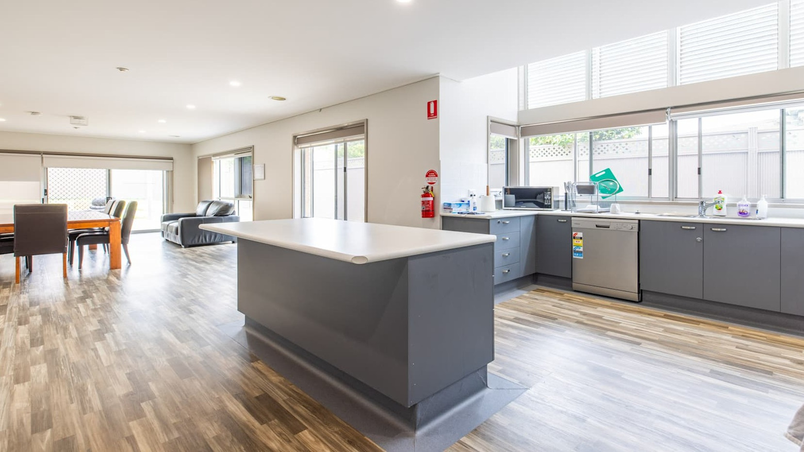 Open plan kitchen, overlooking dining and living spaces with access to the rear yard.