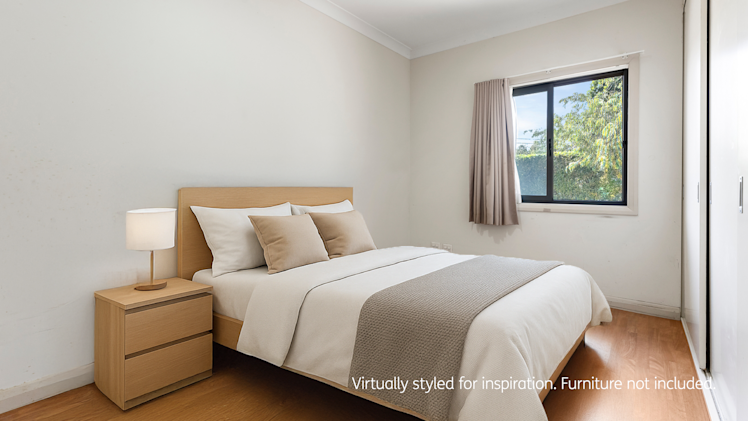 bedroom with hard wood flooring and window.