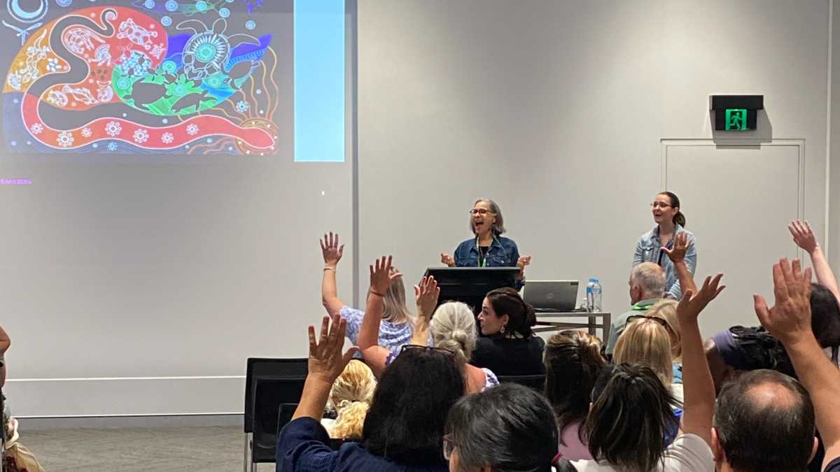 Presentation on Saturday 25 September 2022. Dr Belinda Mayfield speaking. She asked how many carers were in the room and nearly everyone raised their hand.