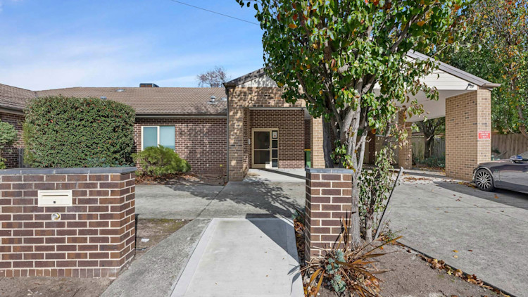 front entrance to red brick, single story house.