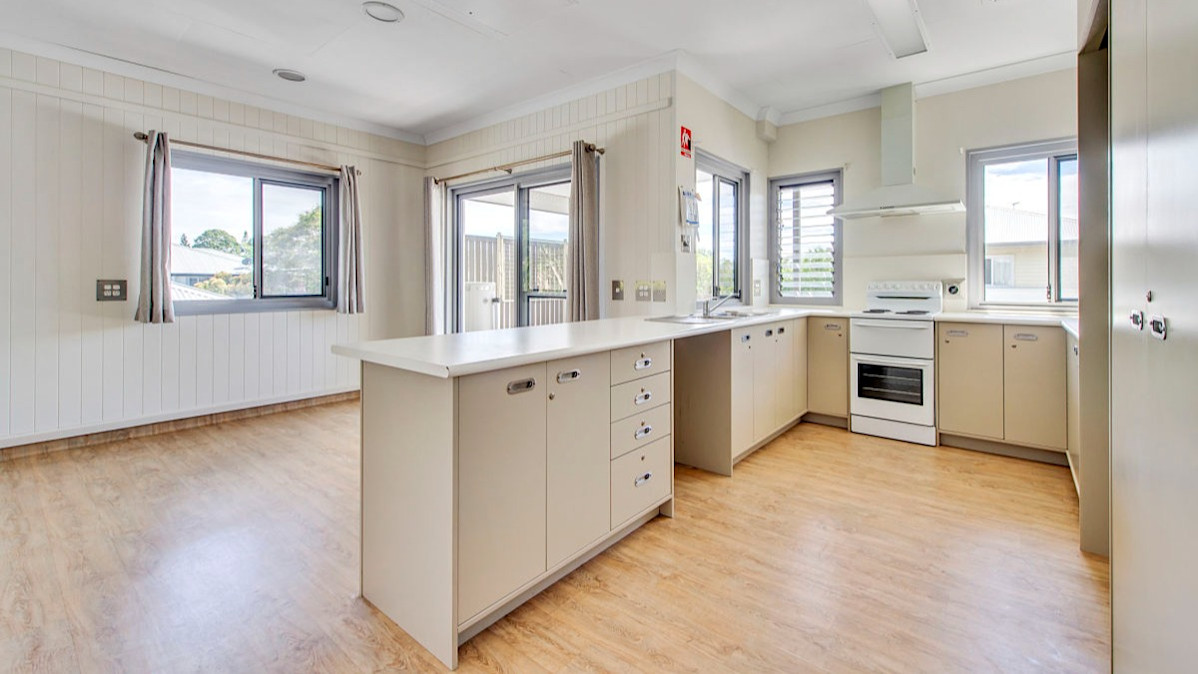 --Wrap around white kitchen and wooden floor boards.--