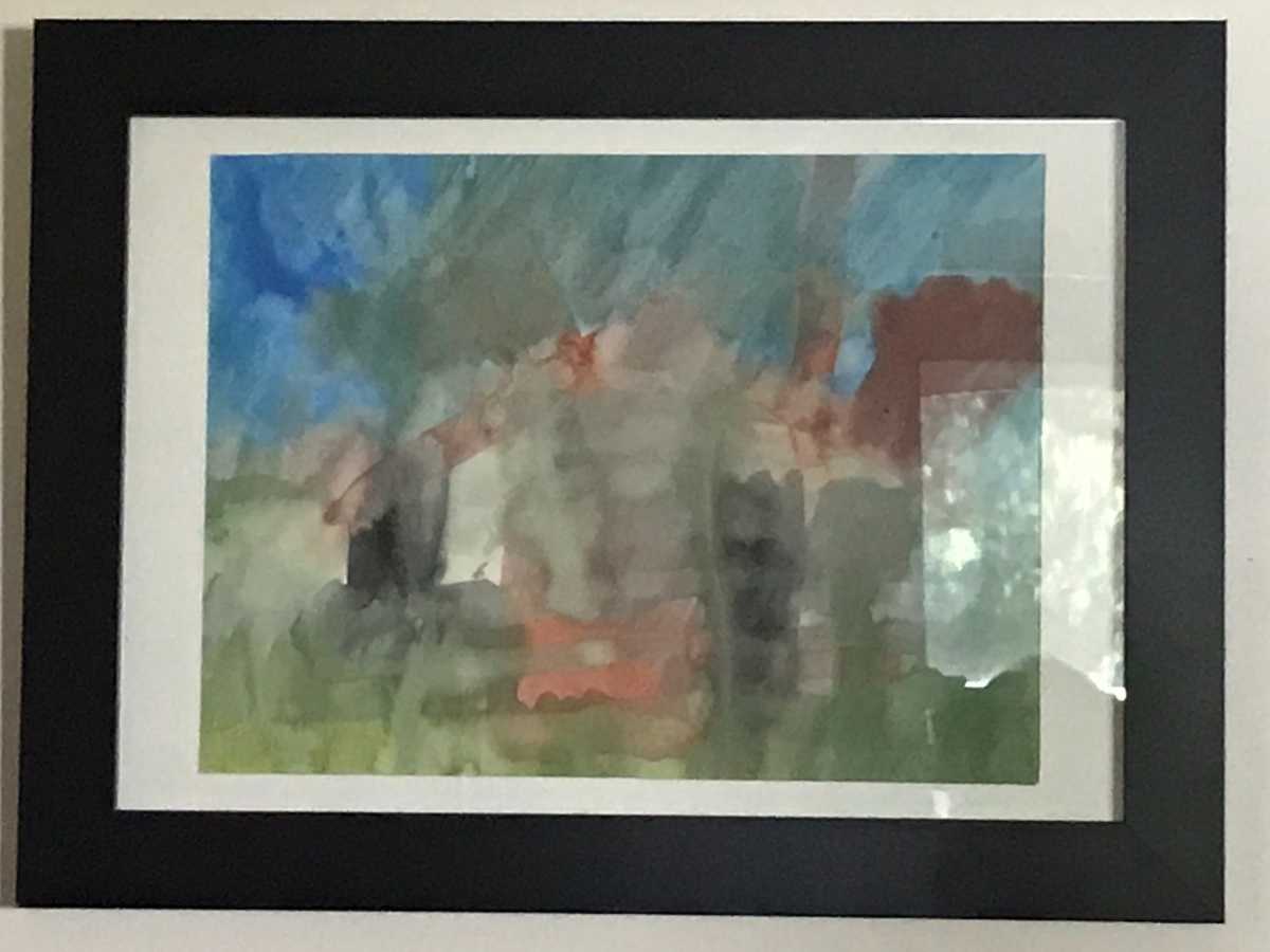 One of Emily's watercolour paintings in a black frame.