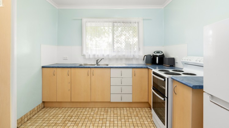 -- Yellow and blue wrap around kitchen.--