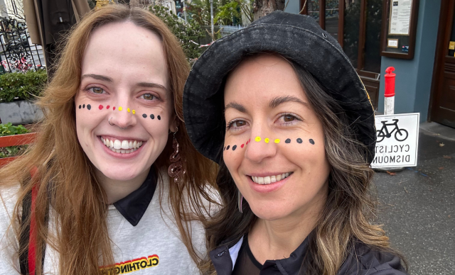 Two staff members with their faces painted at the Naarm NAIDOC March.