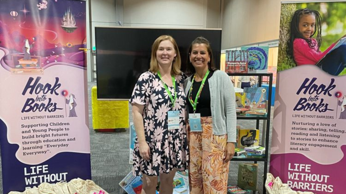 The Education team at IFCO, standing in front of Hook into Books banners.