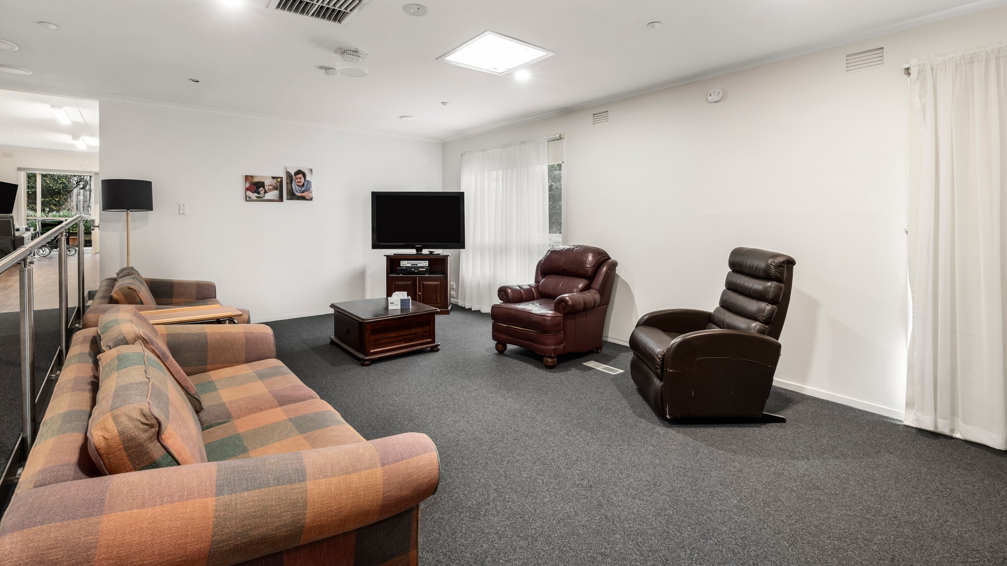Loungeroom with two couches and two armchairs.