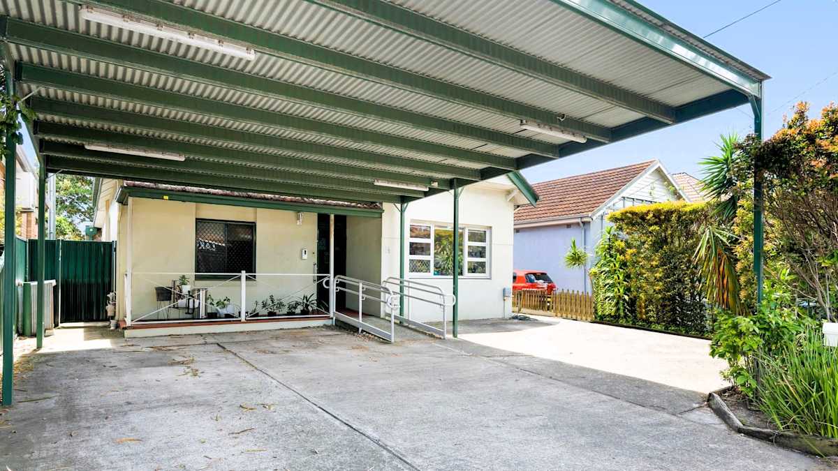 Front entry to house with direct access from undercover carport, ramp to front door.
