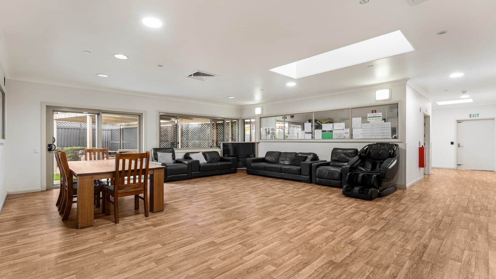 combined lounge and dining space on hardwood floors