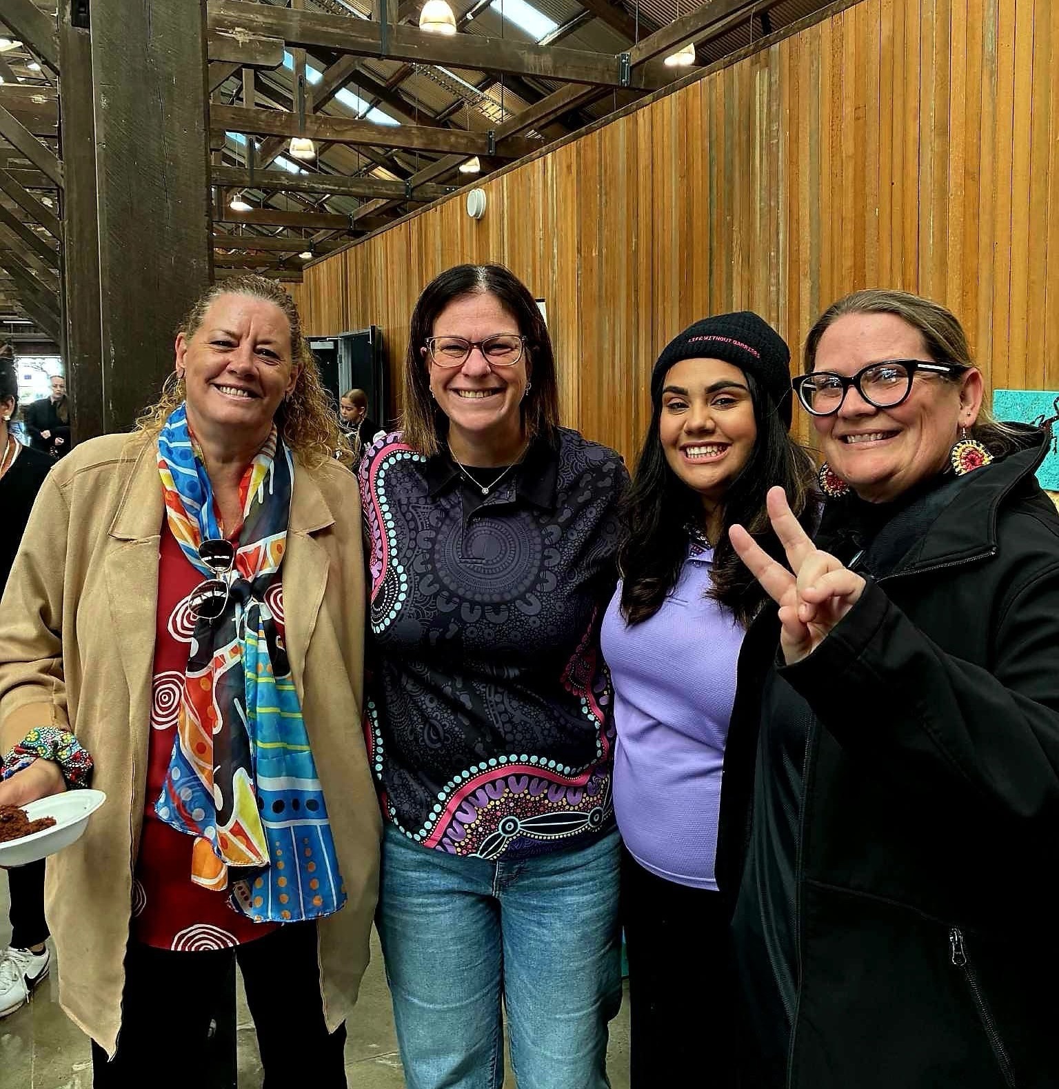 Larisa Dempsey, Program Manager, Kim Robertson, Child and Family Practitioner, Chloe Appo, Program Assistant, and Amee Hetherington, Community Development Officer, at the expo, smiling at the camera.