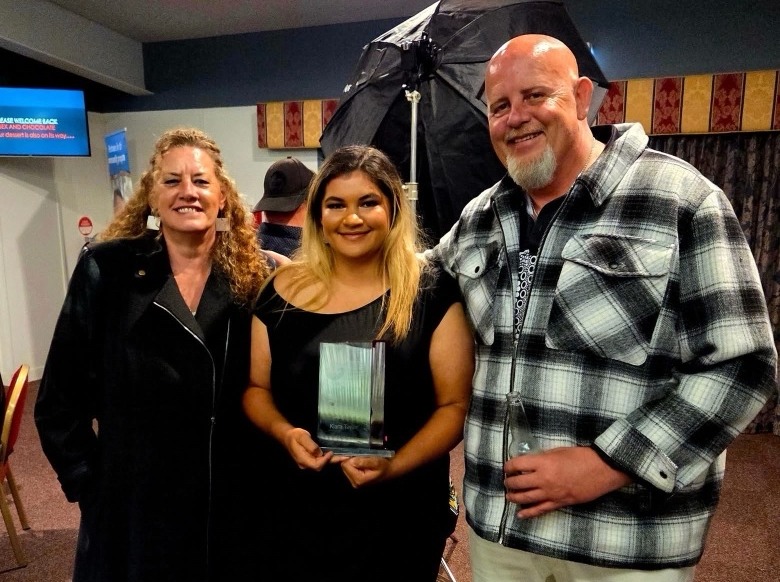 Larissa Dempsey, Program Manager, Kira Taylor, and Jack Dempsey, Program Manager at the gala dinner, smiling at the camera.