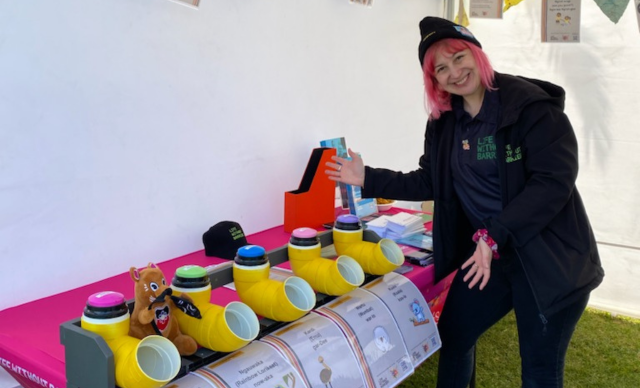 Phi Theodoros stands next to the Kaurna words activity at the Life Without Barriers stall.