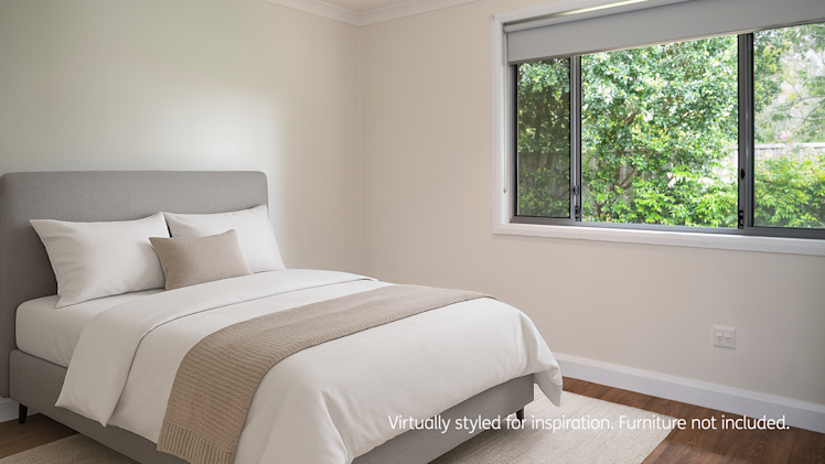Bedroom with wooden floors, and a large window.