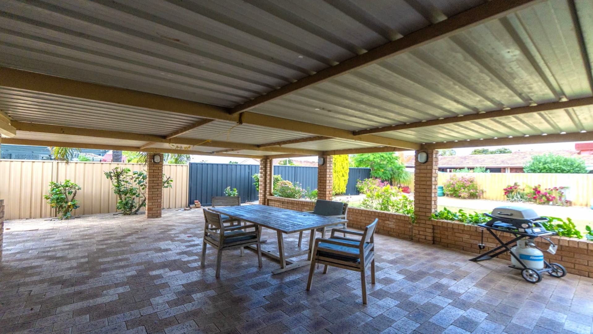 undercover patio with outdoor table and chairs, BBQ.