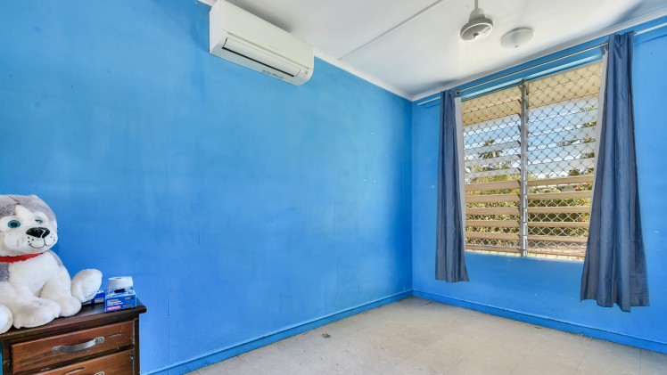 --Bedroom with bright blue walls, tile floor, large window. --
