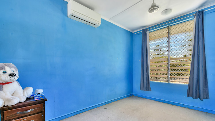 --Bedroom with bright blue walls, tile floor, large window. --
